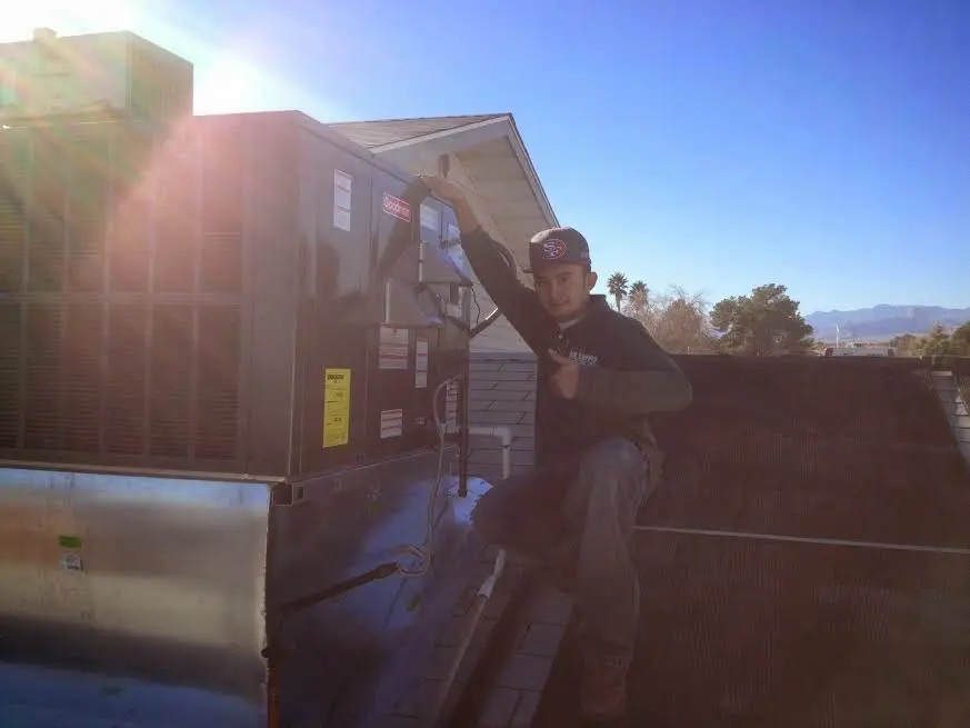 HVAC technician performing HVAC Inspection on a rooftop unit in Coxsackie